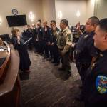From left, Officer Thomas Edgington, Officer Alex Hamrick, Officer Jedediah Johnson, Officer Ernie Grimes Jr., Officer Phillip Charles, Officer Daniel Point, Sgt Jimmy Thompson and Chief Samuel White of Lower Elwha Police Department are sworn in. (Jesse Major/Peninsula Daily News)