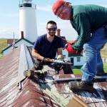 Volunteers spruce up the New Dungeness Light Station during an annual work week effort in mid-September. The New Dungeness Light Station Association will host its annual meeting Saturday. (New Dungeness Light Station Association)
