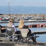 Visitors take in the view of the Van Ripers Resort moorage docks in Sekiu. (Lonnie Archibald/for Peninsula Daily News)