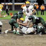 Port Angeles football players tackle a Kingston ball carrier on the Civic Field infield during a game earlier this season at Civic Field. (Keith Thorpe/Peninsula Daily News)