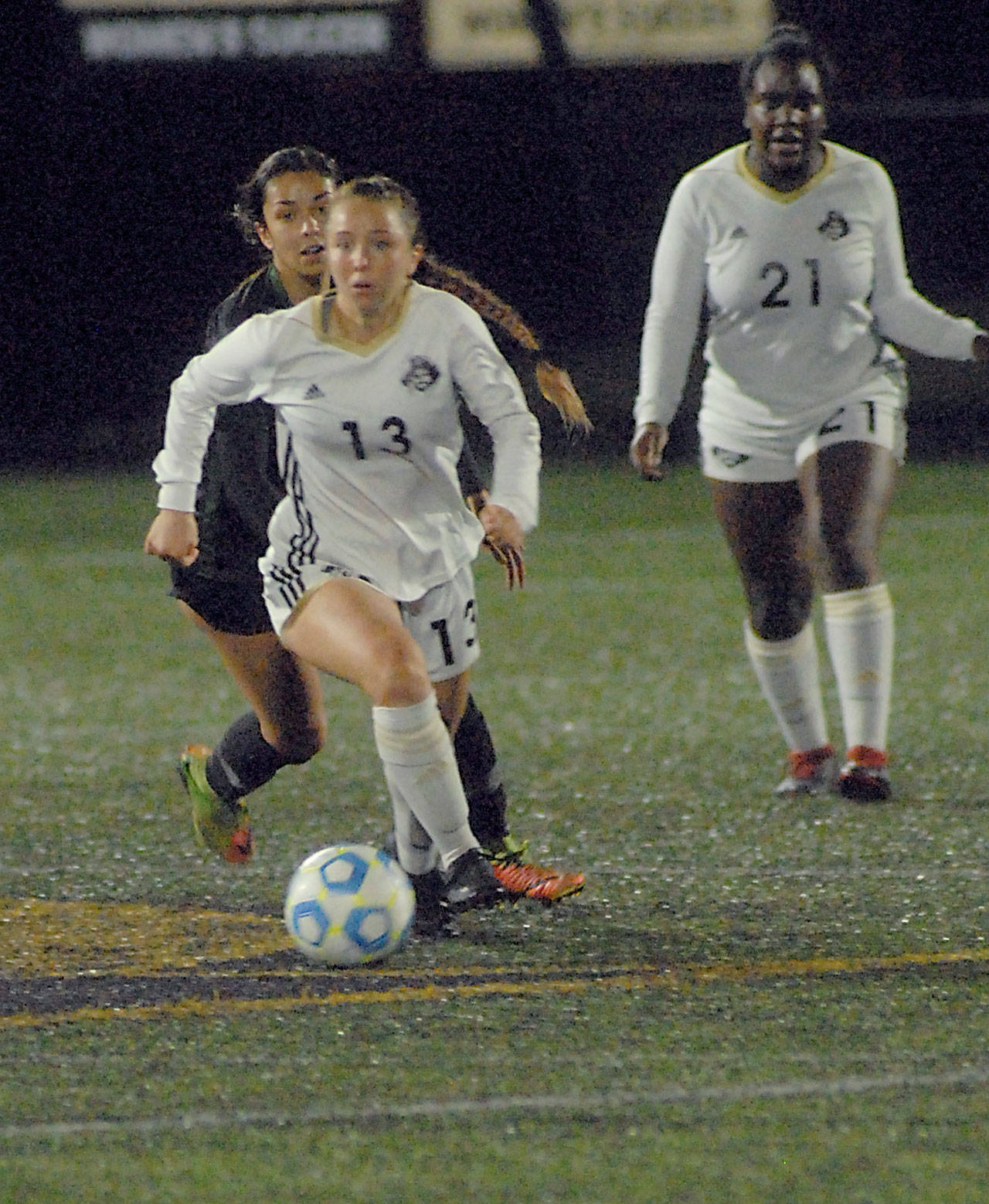 Peninsulas Grace Hipke, front, outruns Shorelines Julia Olvera as Hipkes teammate Tommylia Dunbar, right, looks on during Wednesday nights match at Wally Sigmar Field in Port Angeles. (Keith Thorpe/Peninsula Daily News)