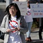 In this photo taken Oct. 11, 2019, Linda Yang, of the Let People Vote campaign, is seen at a demonstration against I-1000, in Bellevue. More than two decades after Washington voters banned affirmative action, the question of whether ones minority status should be considered as a contributing factor in state employment, contracting and admission to public colleges and universities is back on the ballot. The Nov. 5 vote comes months after the Legislature approved Initiative 1000 in April, on the final day of this years legislative session. Opponents of the measure collected enough signatures to force a referendum, Referendum 88, and now voters will have the final say on whether I-1000 should become law.(AP Photo/Elaine Thompson)
