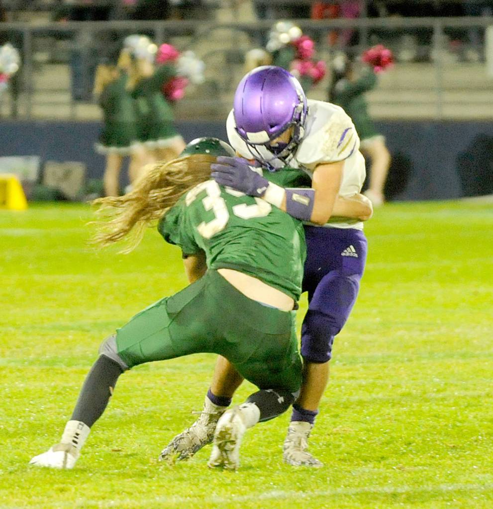 Michael Dashiell/Olympic Peninsula News Group Port Angeles Derek Bowechop tackles a Sequim runner during the Rainshadow Rumble on Friday night at Civic Field.