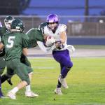 Michael Dashiell/Olympic Peninsula News Group Sequims Michael Young runs with the football during the Rainshadow Rumble on Friday night at Civic Field.