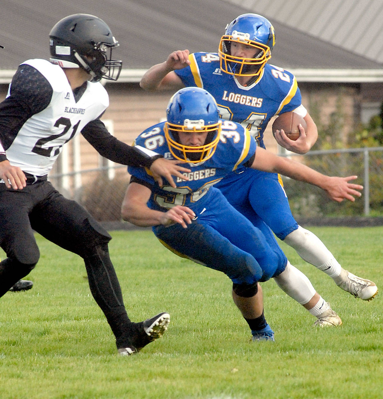 Keith Thorpe/Peninsula Daily News Crescents Brayden Emery, right, gets a block from his brother, Eric Emery, as they fend off the defense of Lummi Nations Caleb Revey, left, on Saturday in Joyce.