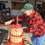 Sequims Alan Kingsbury works his cider press a few times a year. He hopes to press about 14 bottles of cider each year to last until the next season. (Matthew Nash/Olympic Peninsula News Group)