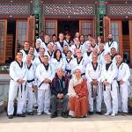 An American taekwondo delegation, including White Crane instructors and students, visits a Buddhist temple in Korea.