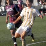 Keith Thorpe/Peninsula Daily News Peninsulas Hide Inoue, front, keeps the ball from Whatcoms Musab Bwana during Saturdays match at Wally Sigmar Field in Port Angeles.
