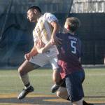 Keith Thorpe/Peninsula Daily News Peninsulas Pablo Medina, left, angles a header away from the defense of Whatcoms Thomas Watson on Saturday in Port Angeles.