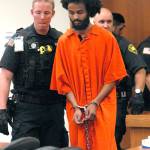 Abdinjib Ibraham, a prison inmate who allegedly tried to kill a Clallam Bay Corrections Center deputy in 2016, enters Clallam County Superior Court accompanied by state corrections security officers Wednesday in Port Angeles. (Keith Thorpe/Peninsula Daily News)