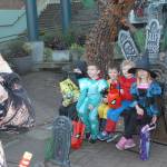 Brett Stigall of Port Angeles, left, takes a photo of youngsters, from left, Dawkin Stigall, 7, Cael Stigall, 6, Tydus Stigall, 4, Gary Proutt, 3, and Gloria Proutt, 5, at the plaza at the Conrad Dyar Memorial Fountain in downtown Port Angeles on Halloween. (Keith Thorpe/Peninsula Daily News)