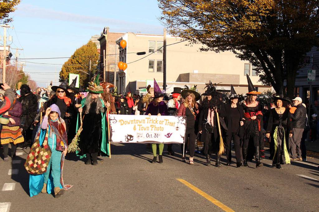 The Port Townsend Main Street Witches lead off the Halloween Parade through downtown Water Street in Port Townsend on Thursday Afternoon. (Zach Jablonski/Peninsula Daily News)
