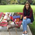 Jessica Dietzman, P.E.O. Chapter JC Star Scholarship nominee, admires the quilted items slated for the Nov. 2 P.E.O. Holiday Bazaar silent auction. (Kathy Cox)