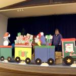 Jefferson County Fair Agriculture Superintendent Debbie Rasmussen helps set the stage where pictures with Santa will be taken at the Holiday Fair this weekend at the Jefferson County Fairgrounds. (Zach Jablonski/Peninsula Daily News)