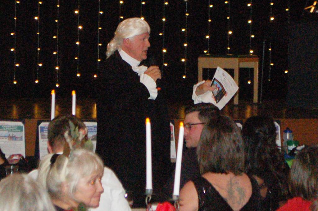 Vern Frykholm, portraying George Washington, served as the auctioneer for the Mosaic Masquerade fundraising event for Clallam Mosaic. (Conor Dowley/Olympic Peninsula News Group)