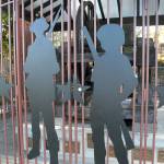 The silhouettes of two Revolutionary War soldiers adorn a decorative fence that was recently installed to protect the Liberty Bell replica from vandalism in Veterans Memorial Park in Port Angeles. (Keith Thorpe/Peninsula Daily News)
