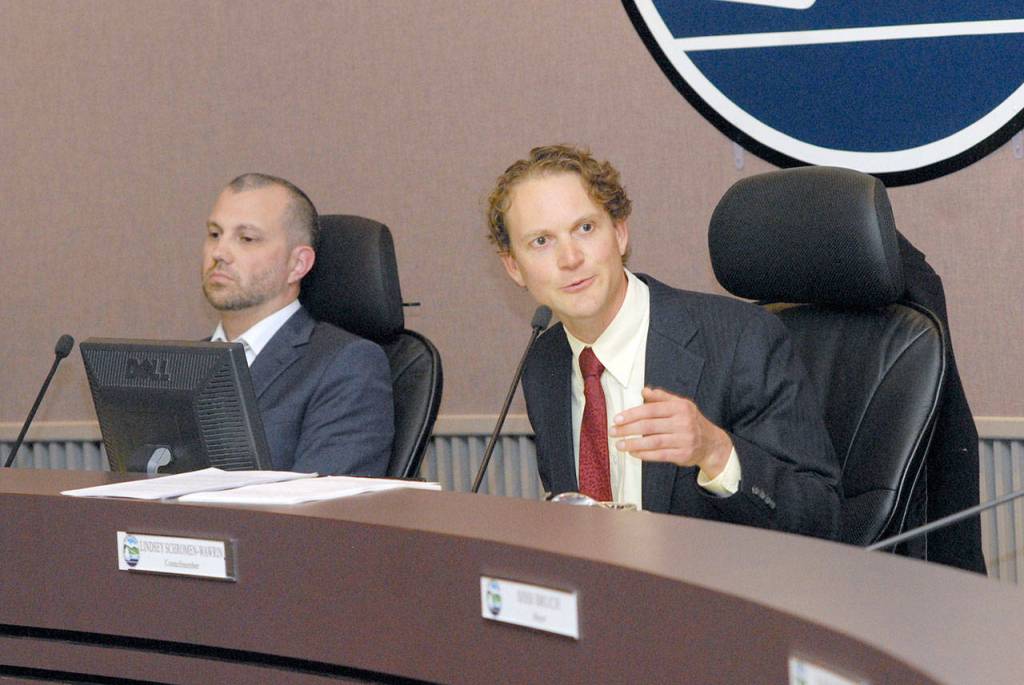 Port Angeles City Council Member Lindsey Schromen-Wawrin right makes his point against demoting Mayor Sissi Bruch as fellow Council Member Mike French listens Wednesday. (Keith Thorpe/Peninsula Daily News)