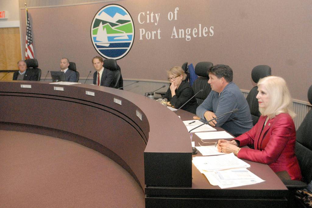 Port Angeles Deputy Mayor Kate Dexter, center, conducts Wednesdays city council meeting next to an empty seat that was occupied by Mayor Sissi Bruch after Bruch recused herself from a council motion and discussion to strip her mayoral title. (Keith Thorpe/Peninsula Daily News)