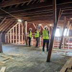 Clark Construction Group employees are seen in the attic of Building 305 at Fort Worden, which is currently being renovated as part of the Makers Square project. (Clark Construction Group)