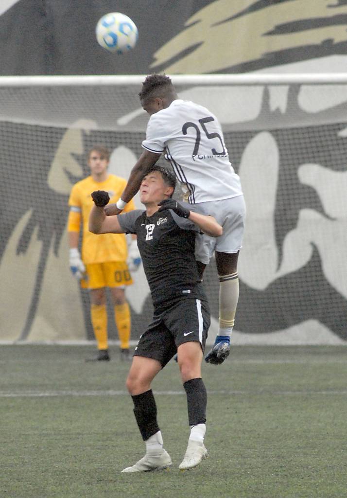 Peninsulas Nick Namwali goes up and over Wenatchee Valleys Hector Solorio on Saturday in Port Angeles. (Keith Thorpe/Peninsula Daily News)