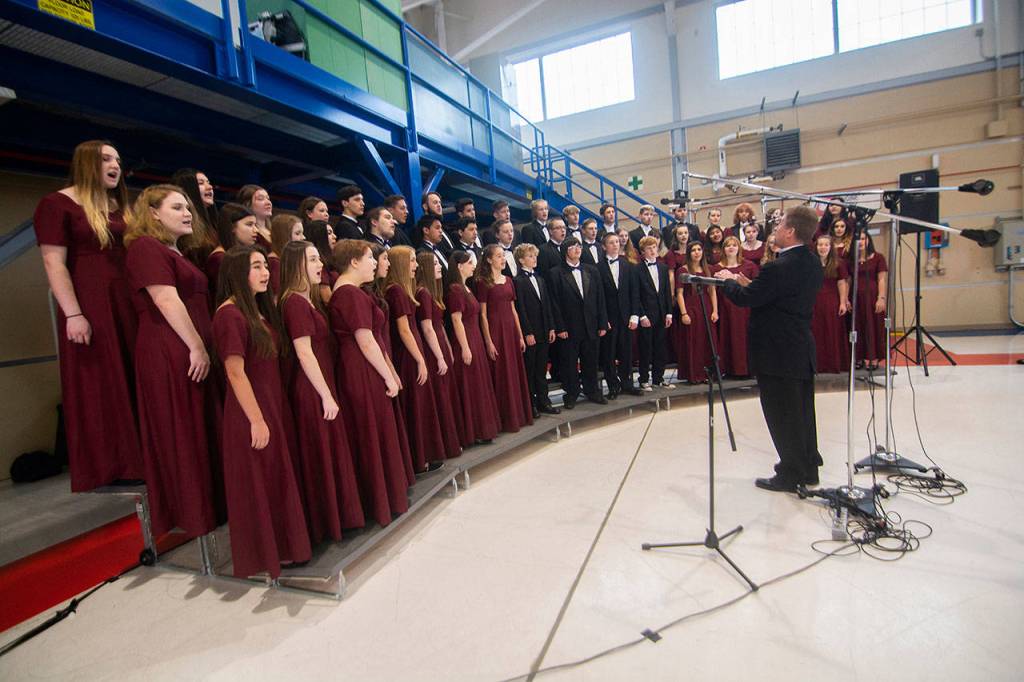 The Sequim High School Select Choir performs during the Veterans Day ceremony at U.S. Coast Guard Air Station/Sector Field Office Port Angeles on Monday. (Jesse Major/Peninsula Daily News)
