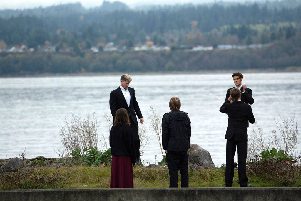 Students wait outside the hangar before the Veterans Day ceremony at U.S. Coast Guard Air Station/Sector Field Office Port Angeles on Monday. (Jesse Major/Peninsula Daily News)