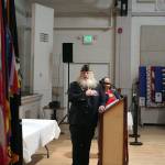 Port Townsend American Legion Post 26 Commander Charles Thomas sings along with Selena Espinoza during the national anthem Monday. (Brian McLean/Peninsula Daily News)