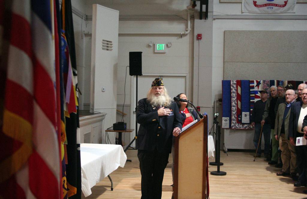 Port Townsend American Legion Post 26 Commander Charles Thomas sings along with Selena Espinoza during the national anthem Monday. (Brian McLean/Peninsula Daily News)