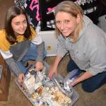 River Jensen, left, continues to gather toiletries with her mom Anna to create bags for people in need this holiday season. (Matthew Nash/Olympic Peninsula News Group)