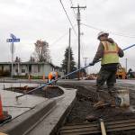 <strong>Michael Dashiell</strong>/Olympic Peninsula News Group                                Tim Coville, foreground, and Peter Gish work on sidewalks along West Fir Street on Tuesday. The citys biggest current project at $3.4 million, the projects completion is tentatively slated for late spring, city staff said.