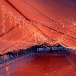Thousands of holiday lights hang from the roof of the tent covering the ice rink at the Port Angeles Winter Ice Village. (Keith Thorpe/Peninsula Daily News)