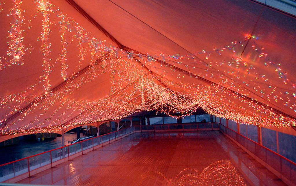 Thousands of holiday lights hang from the roof of the tent covering the ice rink at the Port Angeles Winter Ice Village. (Keith Thorpe/Peninsula Daily News)
