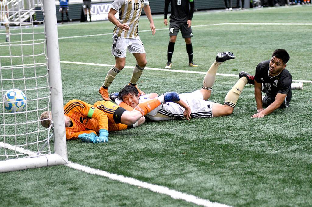 Peninsula Colleges Chunghwan Lee heads in a goal in the first half against Tacoma in Sundays NWAC championship in Tukwila. (Photo courtesy of Peninsula College)