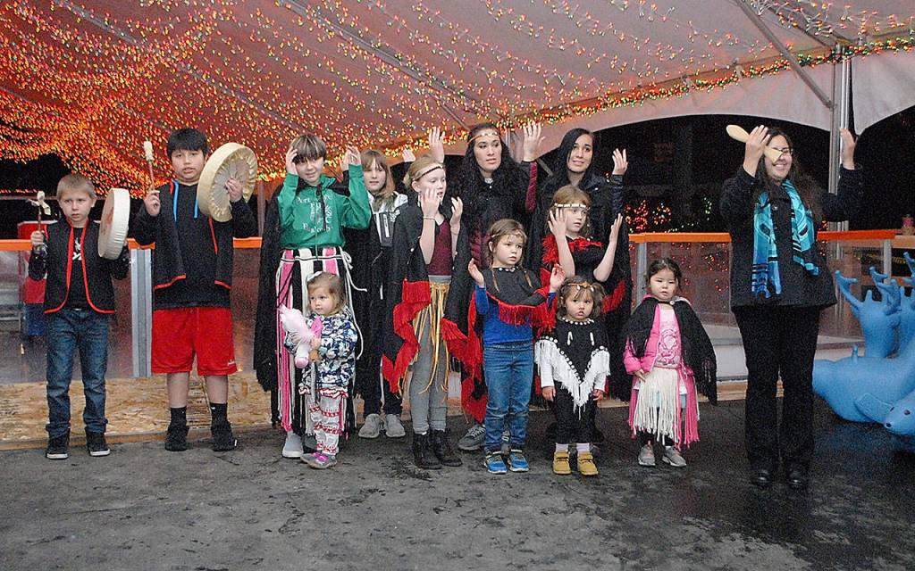 Singers and drummers from the Lower Elwha Klallam Tribe perform a song of welcome at the Winter Ice Village. (Keith Thorpe/Peninsula Daily News)