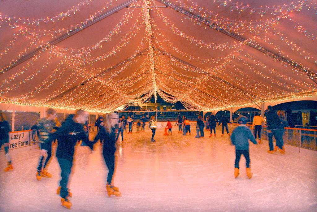 Skaters glide around the ice rink at the Port Angeles Ice Village after the opening ceremony. (Keith Thorpe/Peninsula Daily News)