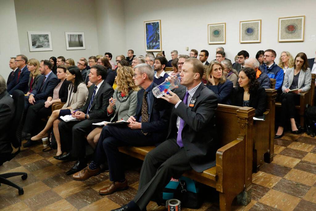 Tim Eyman, lower right, a career anti-tax initiative promoter, drinks water as he attends a King County Superior Court hearing Tuesday, Nov. 26, 2019, in Seattle. (AP Photo/Ted S. Warren)