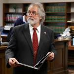 Alan Copsey, an associate solicitor general of the State of Washington, walks back to the defense table after he spoke during a King County Superior Court hearing Tuesday, Nov. 26, 2019, in Seattle. (AP Photo/Ted S. Warren)