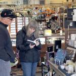 Ron, left, and Linda Jewchyn check out a book for sale at the Green Eyeshade in Port Townsend on Small Business Saturday. The couple from Montesano, Wa, was spending the weekend with family at Fort Worden. (Zach Jablonski/Peninsula Daily News)