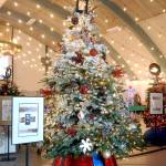 A Christmas tree titled Cranberry Christmas stands tall in Vern Burton Community Center in Port Angeles on Saturday after fetching a top bid of $5,500 at Fridays Festival of Trees gala auction. The tree included the premium of a moving feast of dinner four eight at four downtown Port Angeles eateries, as well as a porch bench. Cranberry Christmas was sponsored by Rinehart Consulting and designed by Molly Smith. (Keith Thorpe/Peninsula Daily News)