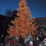 The downtown Port Angeles Christmas tree at the Conrad Dyar Memorial Fountain stands aglow after being lit Saturday evening. The event, which also featured music, hot chocolate and a visit from Santa, drew hundreds of people to the downtown area. (Keith Thorpe/Peninsula Daily News)