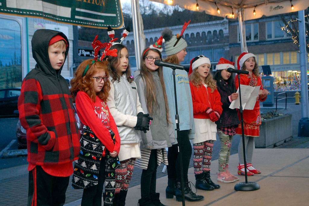 Members of the Hamilton School Winter Choir sing holiday songs during Saturday nights tree lighting ceremony in downtown Port Angeles. (Keith Thorpe/Peninsula Daily News)