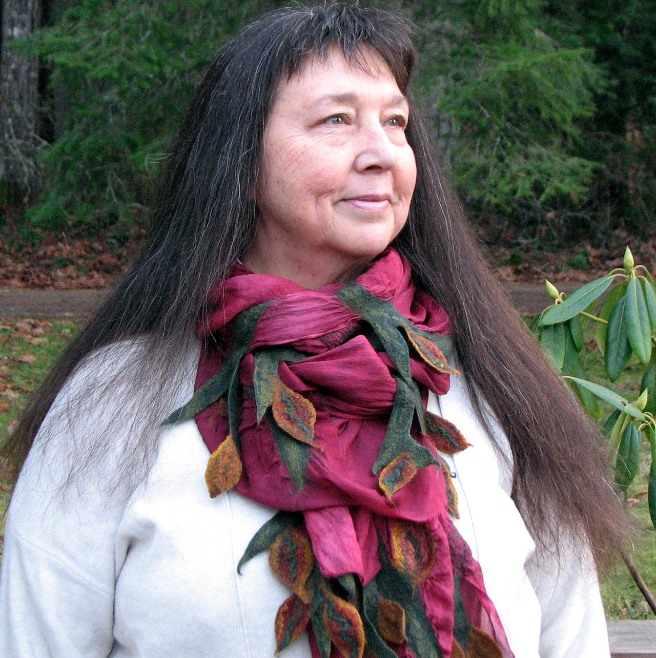 Michelle Johnson, of Port Angeles Laughing Cloud Studio, models one of the scarves shell offer at the Makers Market, opening this Thursday through Dec. 22 at the Port Angeles Fine Arts Center.
