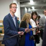 U.S. Rep. Derek Kilmer examines a carbon fiber pole, a light-weight component in pickleball nets, during a tour of the Composite Recycling Technology Center in Port Angeles. (Jesse Major/Peninsula Daily News)