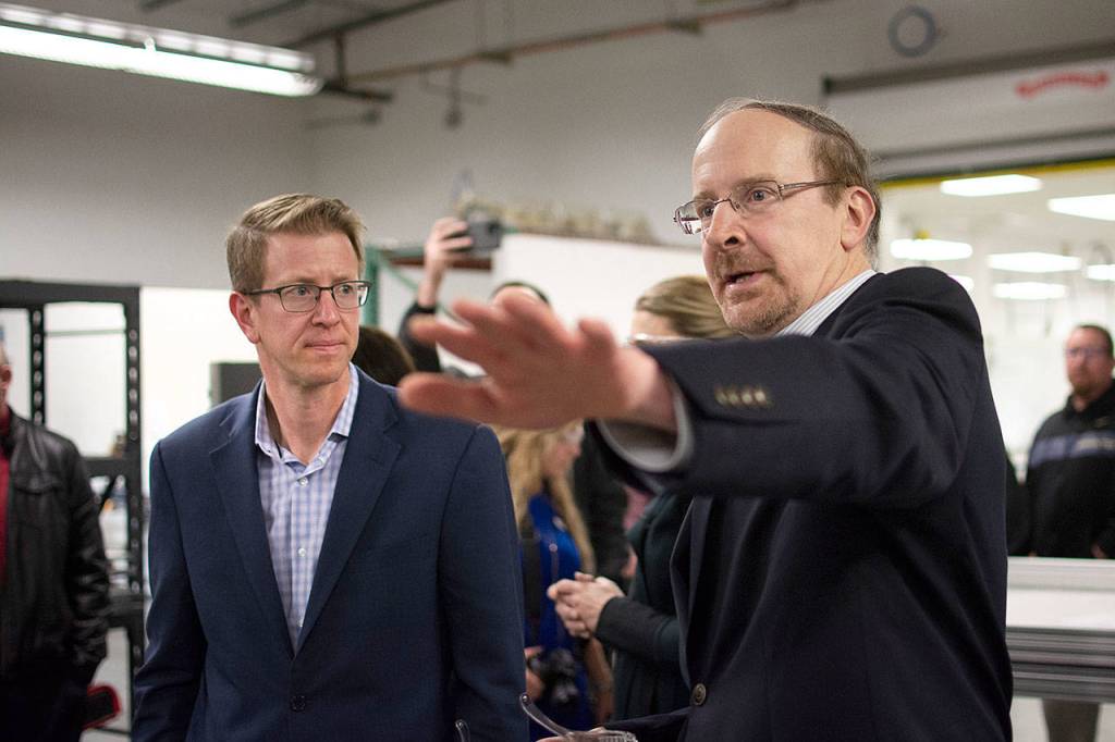 Composite Recycling Technology Center CEO Dave Walter, right, continues the tour of the center. (Jesse Major/Peninsula Daily News)