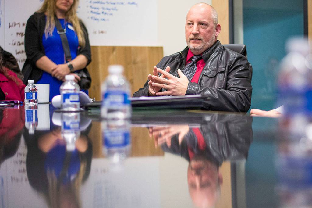 Matthew Rainwater, president of Pennies for Quarters, talks about the nonprofit during a meeting with U.S. Rep. Derek Kilmer and others at the Composite Recycling Technology Center in Port Angeles. (Jesse Major/Peninsula Daily News)