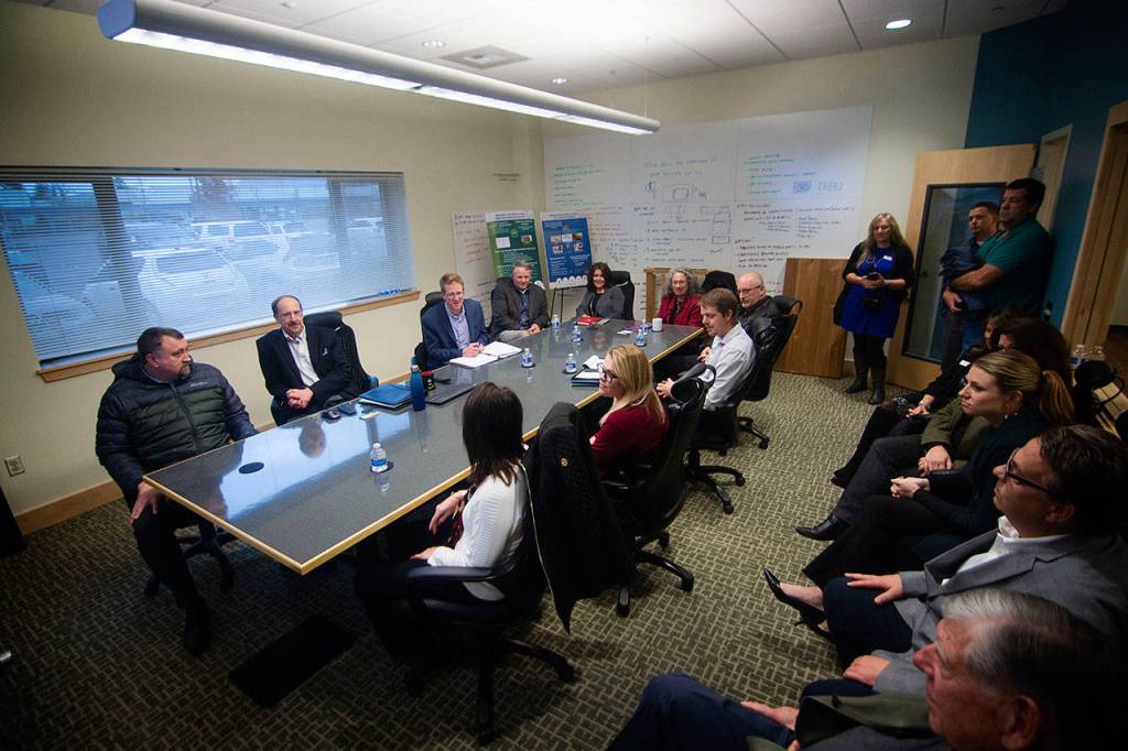 Officials from the Port of Port Angeles, Pennies for Quarters and First Federal pack into the conference room at the Composite Recycling Technology Center during a meeting with U.S. Rep. Derek Kilmer. (Jesse Major/Peninsula Daily News)