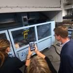U.S. Rep. Derek Kilmer and others look over a 3D printer at the Composite Recycling Technology Center. (Jesse Major/Peninsula Daily News)