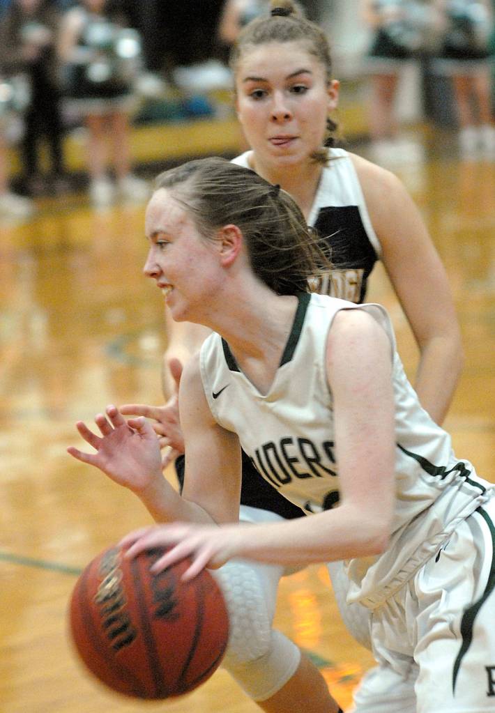Port Angeles Mikkiah Brady, front, slips past Bainbridges Paige Aichele during the second quarter on Tuesday night in Port Angeles. (Keith Thorpe/Peninsula Daily News)