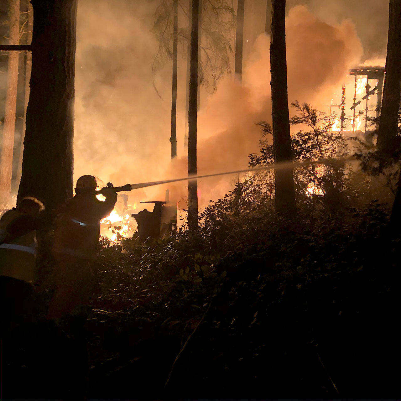 Firefighters work to put out a fire on Alder Street in Coyle on Monday night. No one was injured but the fire consumed a trailer, damaged a guest house and threatened a residential home. (Jefferson County Sheriffs Office)