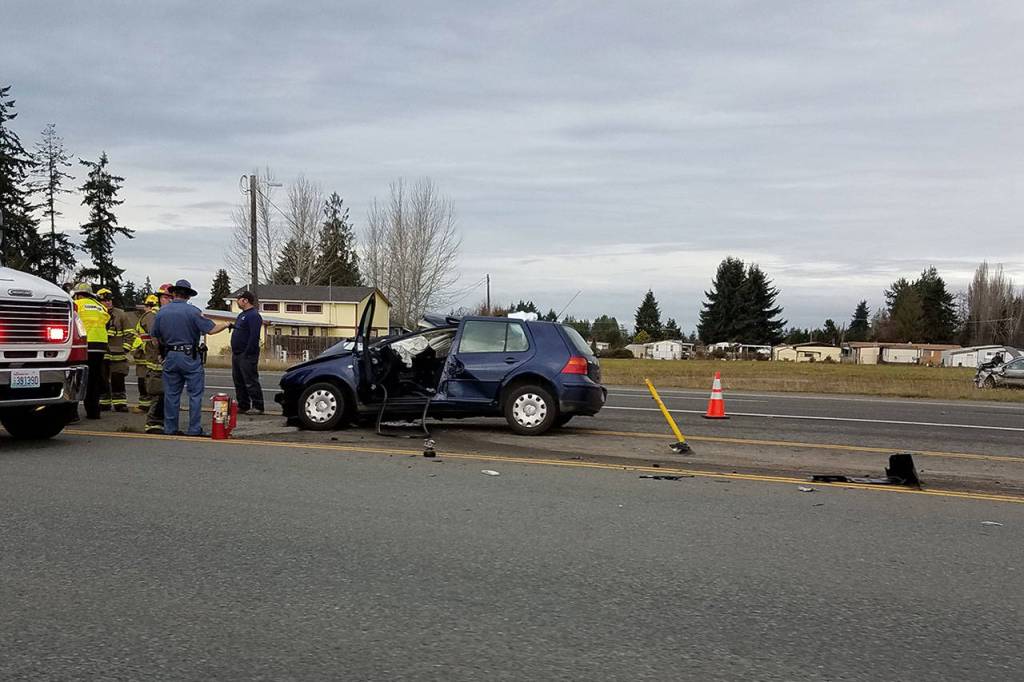 Emergency responders work the scene of a wreck on U.S. Highway 101 in Carlsborg on Tuesday. (Michelle Lynn/Peninsula Daily News)